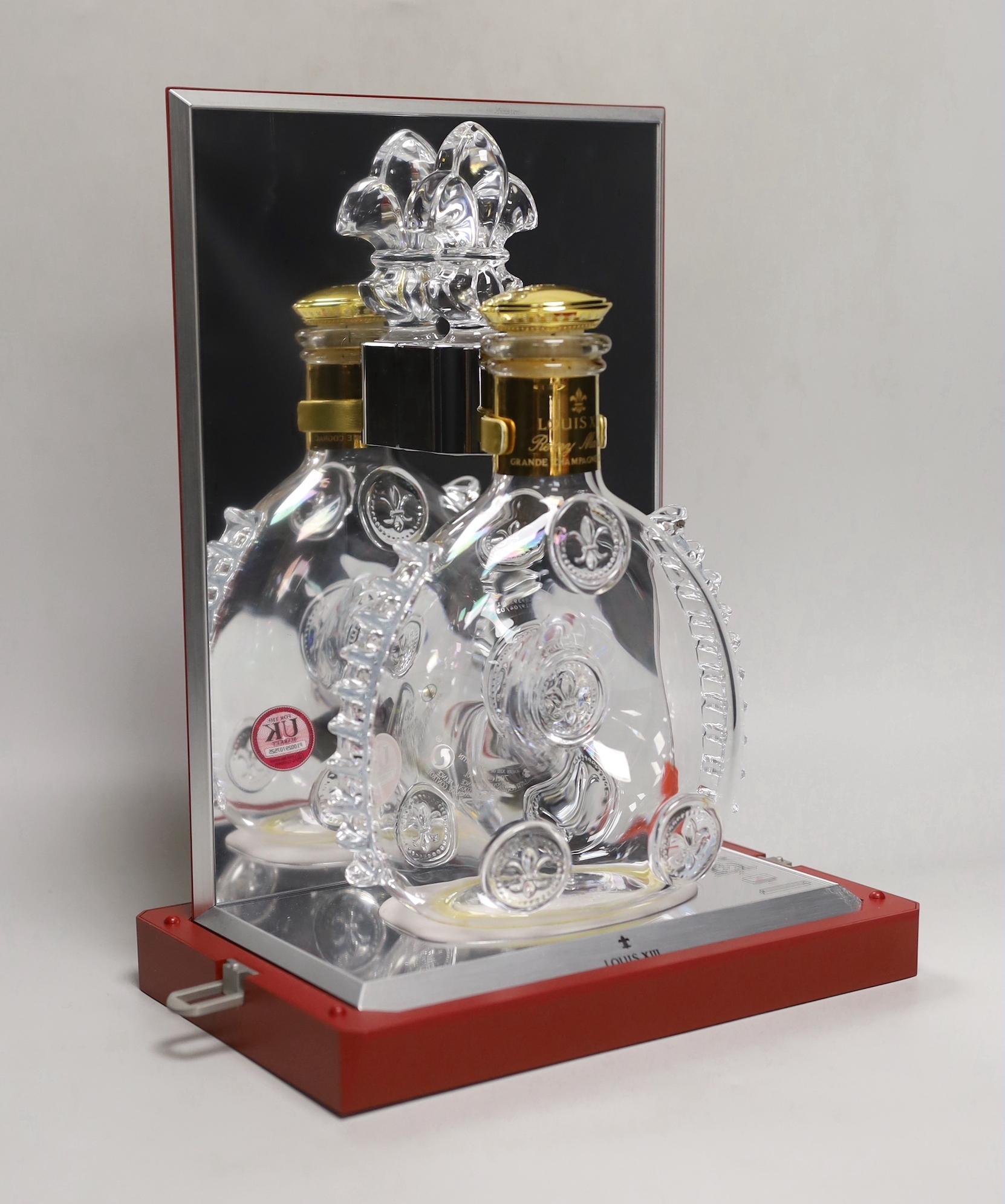 An empty Baccarat Remy Martin Louis XIII decanter, in display case with booklet